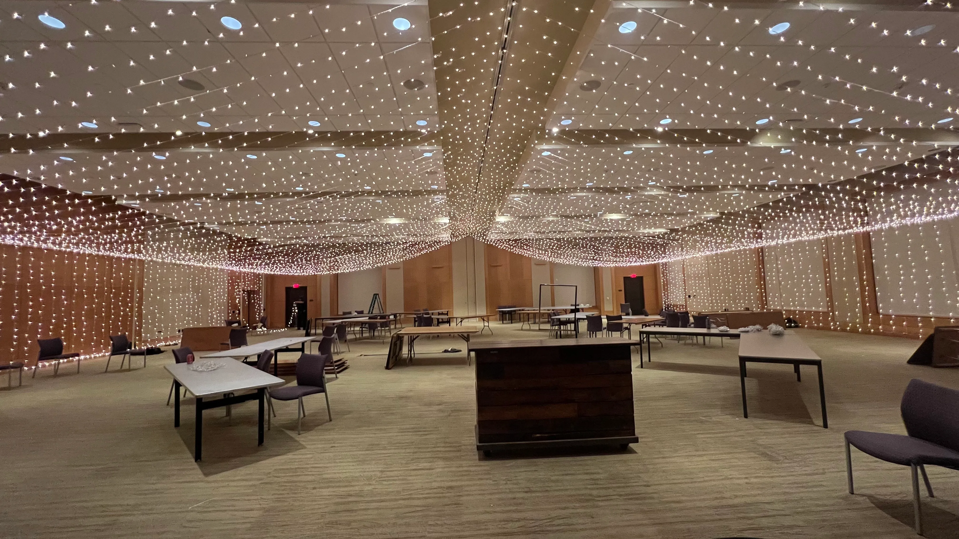 Ballroom ceiling filled with a freshly installed twinkle light canopy before an event